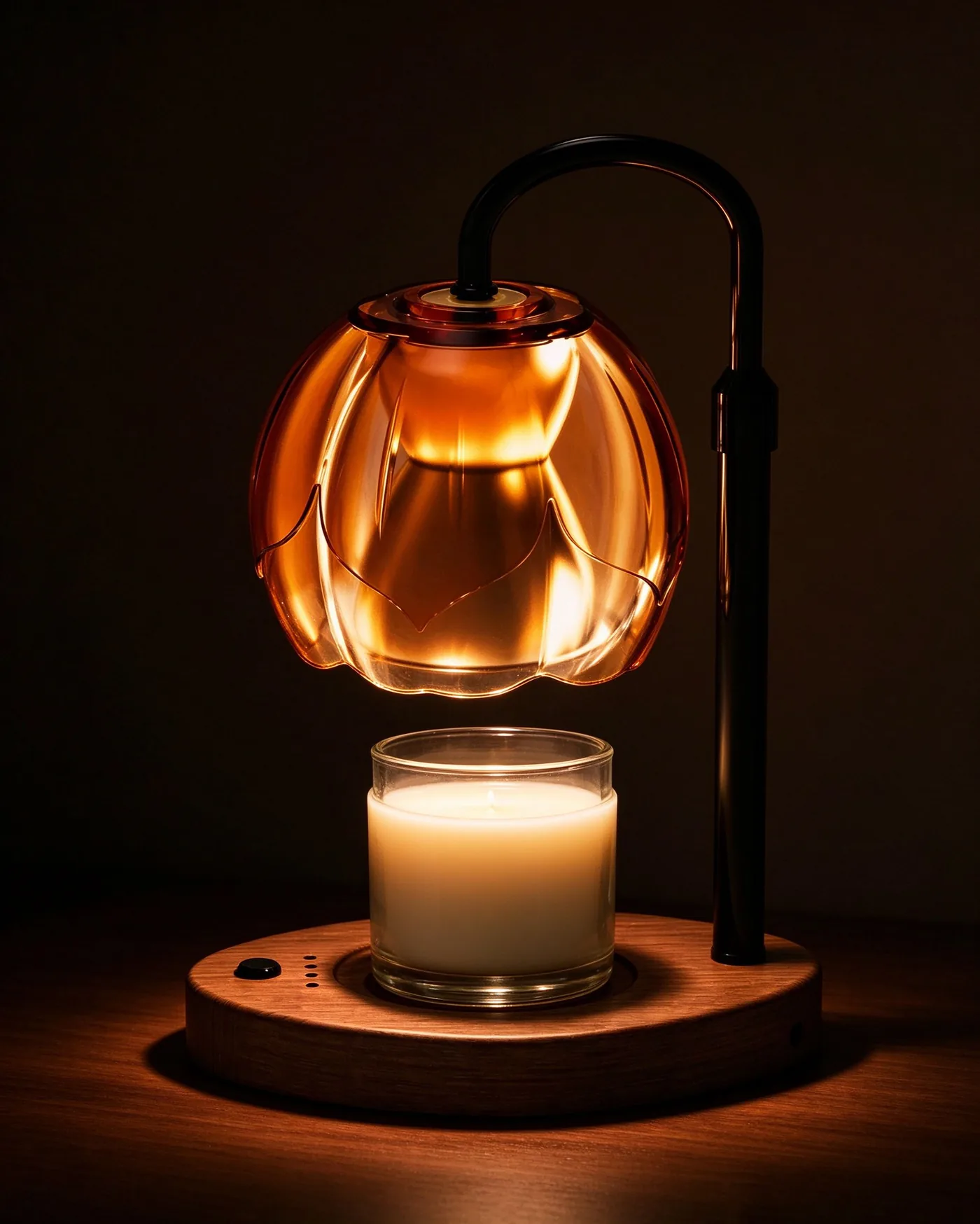 Color-changing candle warmer glowing amber in a dark room