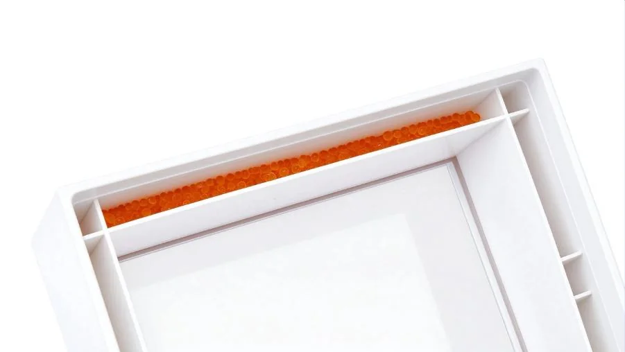 The silica gel compartments inside the Wisedry shadow box.